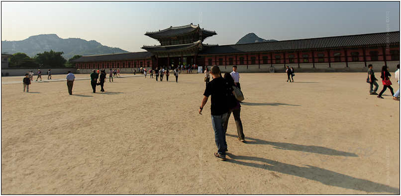 Earlier that afternoon exit five of the Gyeongbokgung subway station led me under the National Palace Museum of Korea out into the large walled off courtyard separating the palace grounds from the city. I walked to the east between the two southern gates to the ticket kiosk and purchased a 3000 won (less than $3 US) entry ticket. With the shadows lengthening I stopped briefly to capture the courtyard and entrance to the reconstructed history of Seoul. 