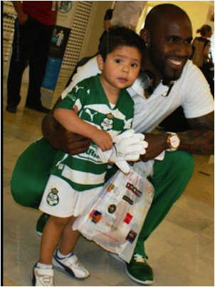 Santos Laguna Player poses with a small child And (accidently) the Playboy magazine he just purchased. I don’t care who you are, this one is funny.