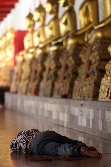 A homeless man captures some zzzzz in a temple down by Thammasat University.