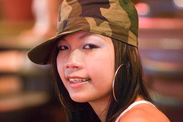 A pretty lady in Pattaya. Don't know if the hat and the ear rings match or not.
