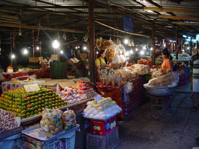 A fruit market in Tak province at dusk.