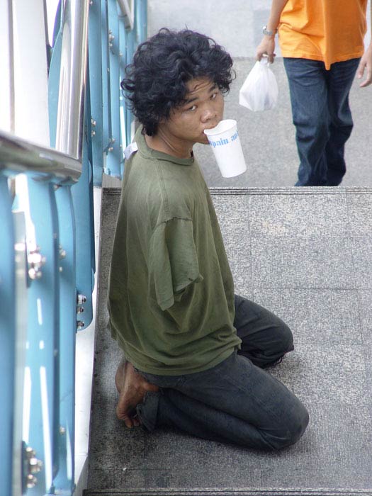 This beggar claims to armless, but his arms are actually tucked inside his shirt!