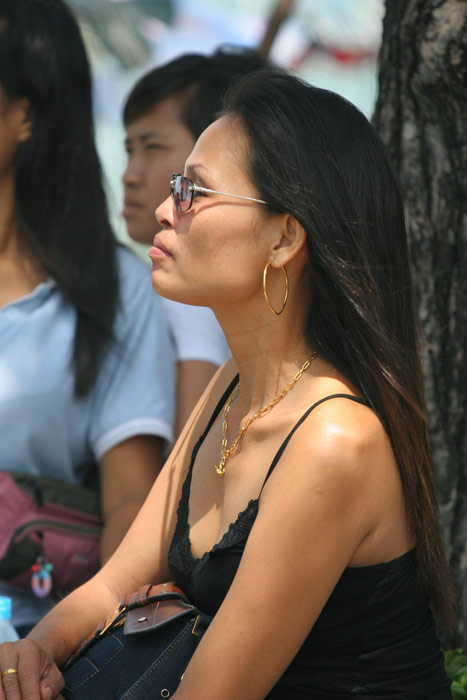 A very attractive lady gazes out to sea. It is unusual to see women wearing gold in Pattaya these days, like this lady is, no doubt due to the increased street crime in recent times.