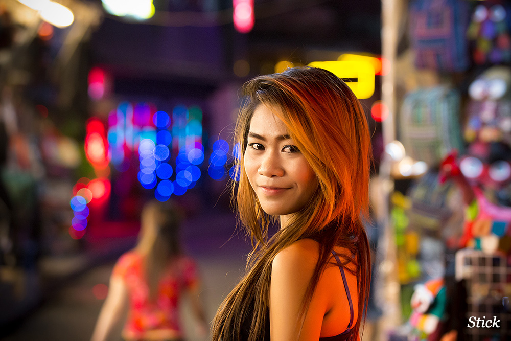 A pretty lady from The Strip outside at a time when Patpong soi 2 was much busier, note all of the shit for sale in the background. 